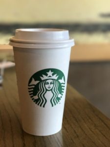 Starbucks coffee cup on table - better photo